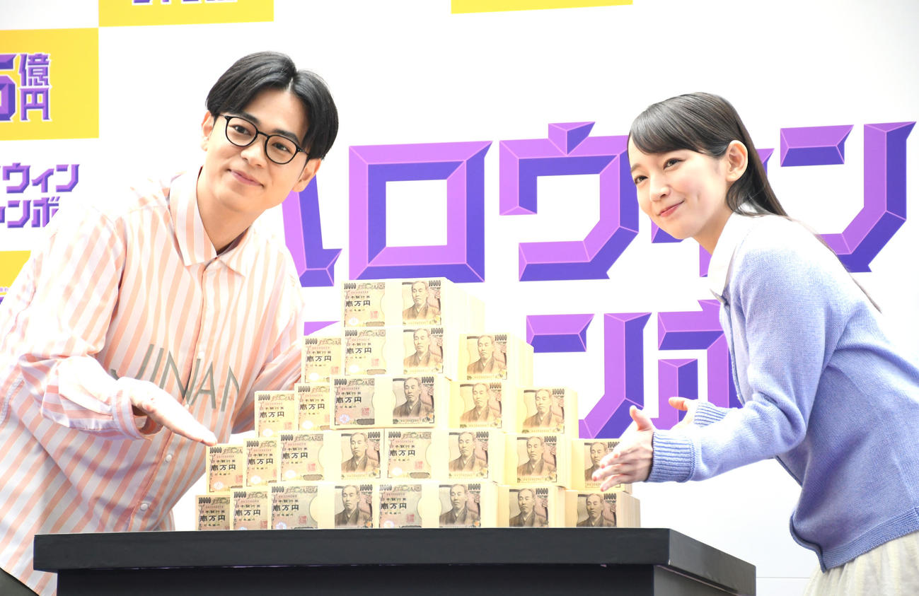 「ハロウィンジャンボ宝くじ」「ハロウィンジャンボミニ」発売記念イベントで5億円のレプリカを前に笑顔の成田凌（左）と吉岡里帆（撮影・大友陽平）