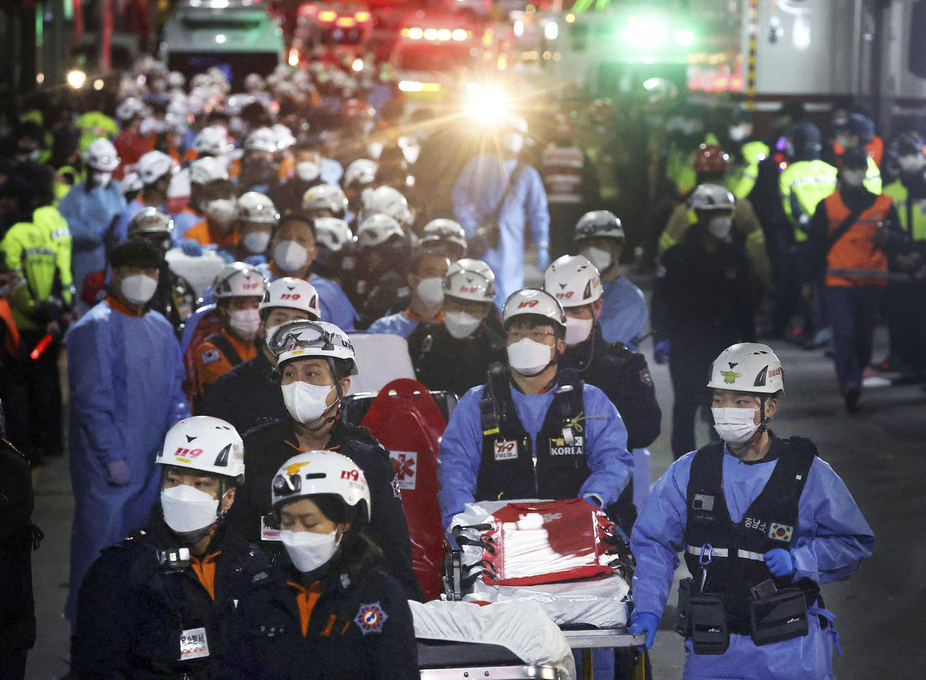 ソウルの繁華街・梨泰院で発生した事故で、負傷者の救助に向かう救急隊員ら＝30日（ロイター＝共同）