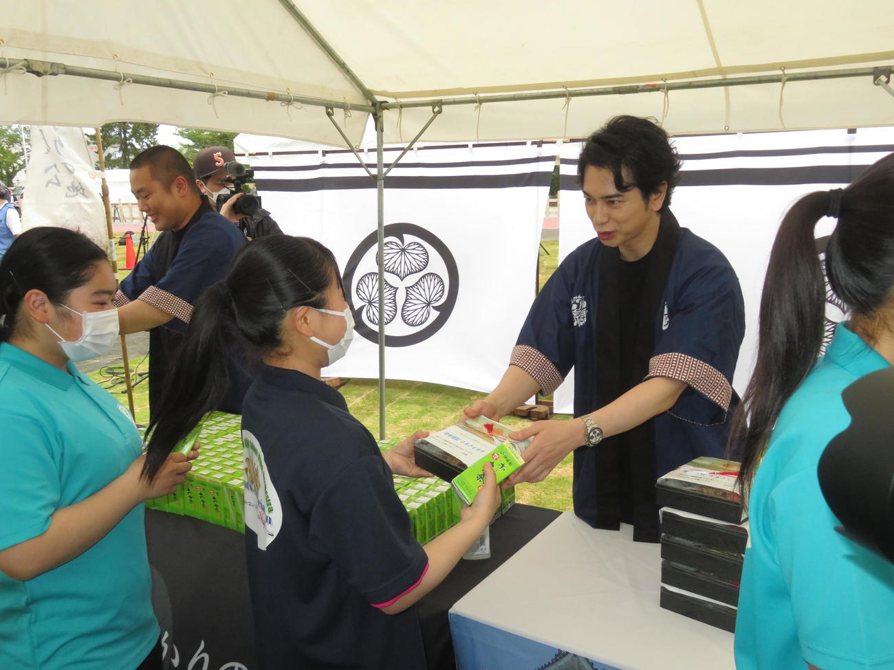 子どもたちにお弁当を手渡す松本潤（奥右）。同左は岡部大（撮影・横山慧）