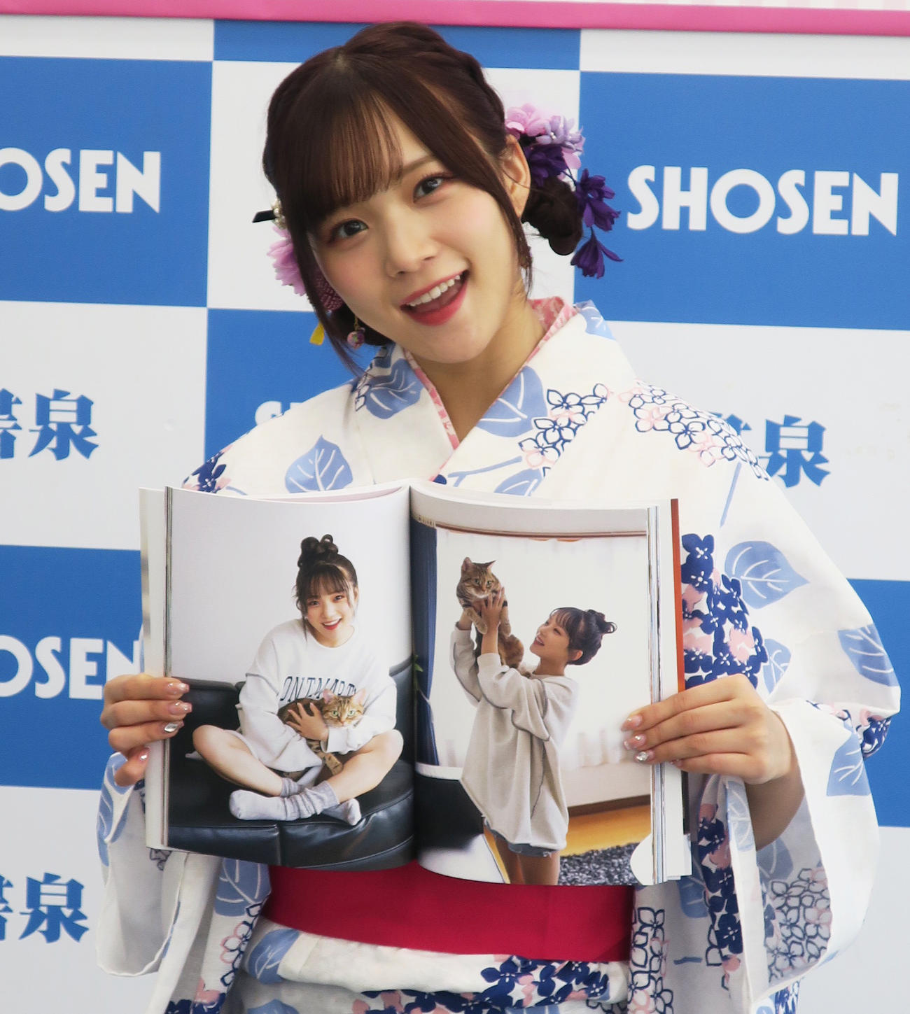 浴衣姿で最新写真集「Love perfume」取材会を行い、お気に入りのページを開く稲場愛香