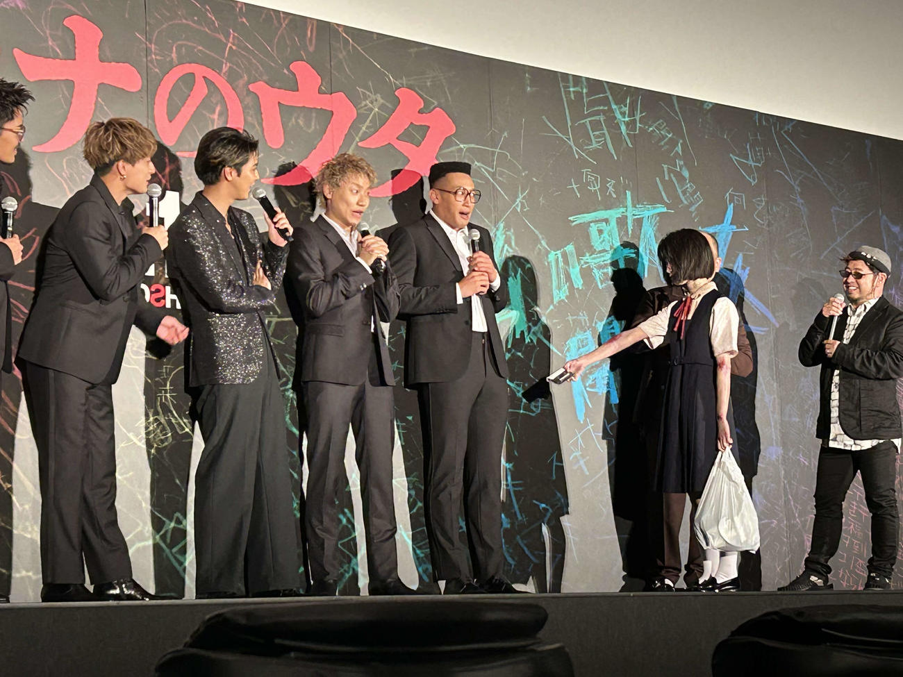 映画「ミンナのウタ」（清水崇監督、8月11日公開）の完成披露試写会で、劇中に登場する少女さなからカセットテープを渡されるGENERATIONSの関口メンディー（左から4人目）（撮影・松尾幸之介）