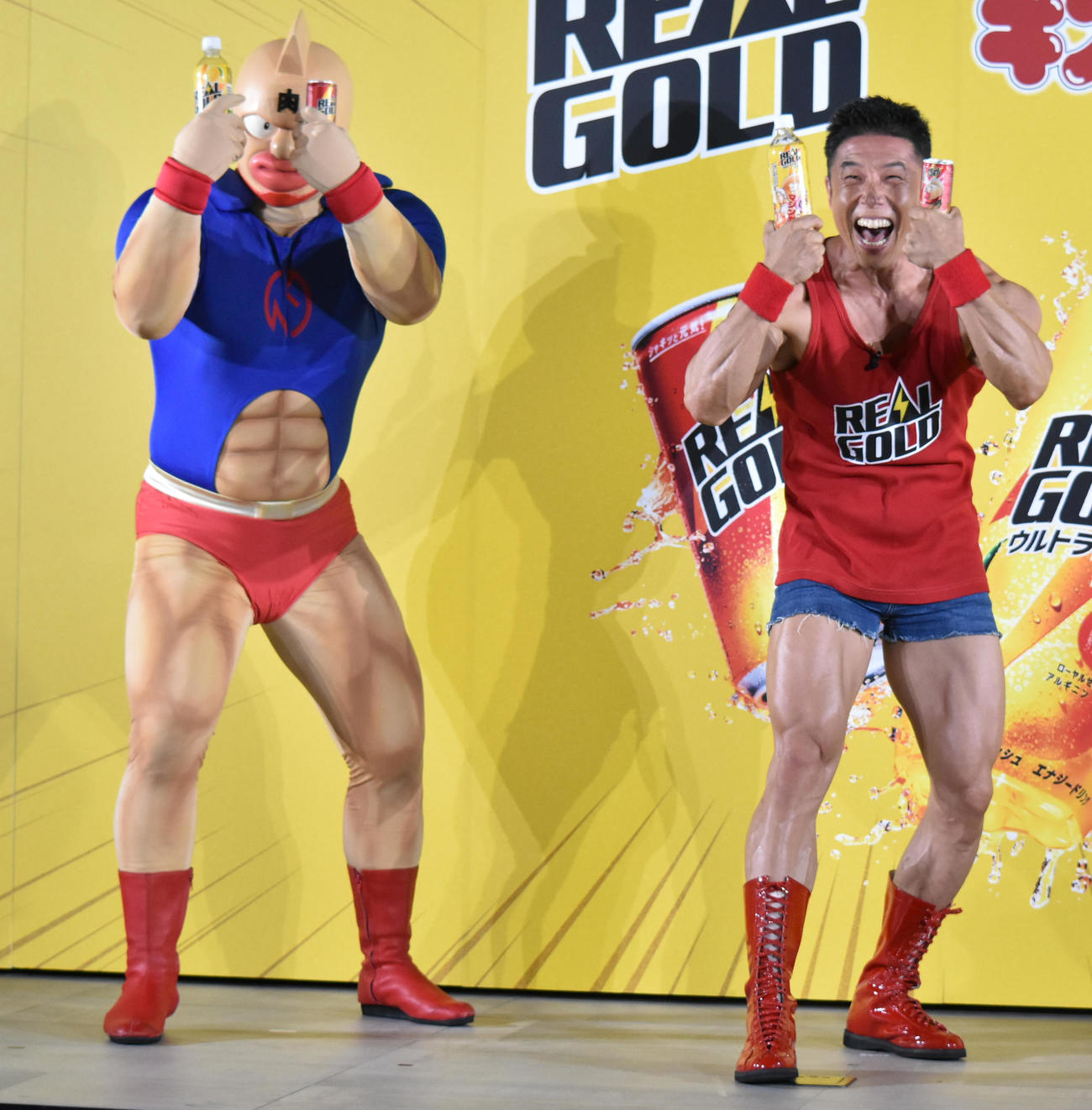 キン肉マンと一緒に「肉のカーテン」ポーズをとるなかやまきんに君（C）YUDETAMAGO