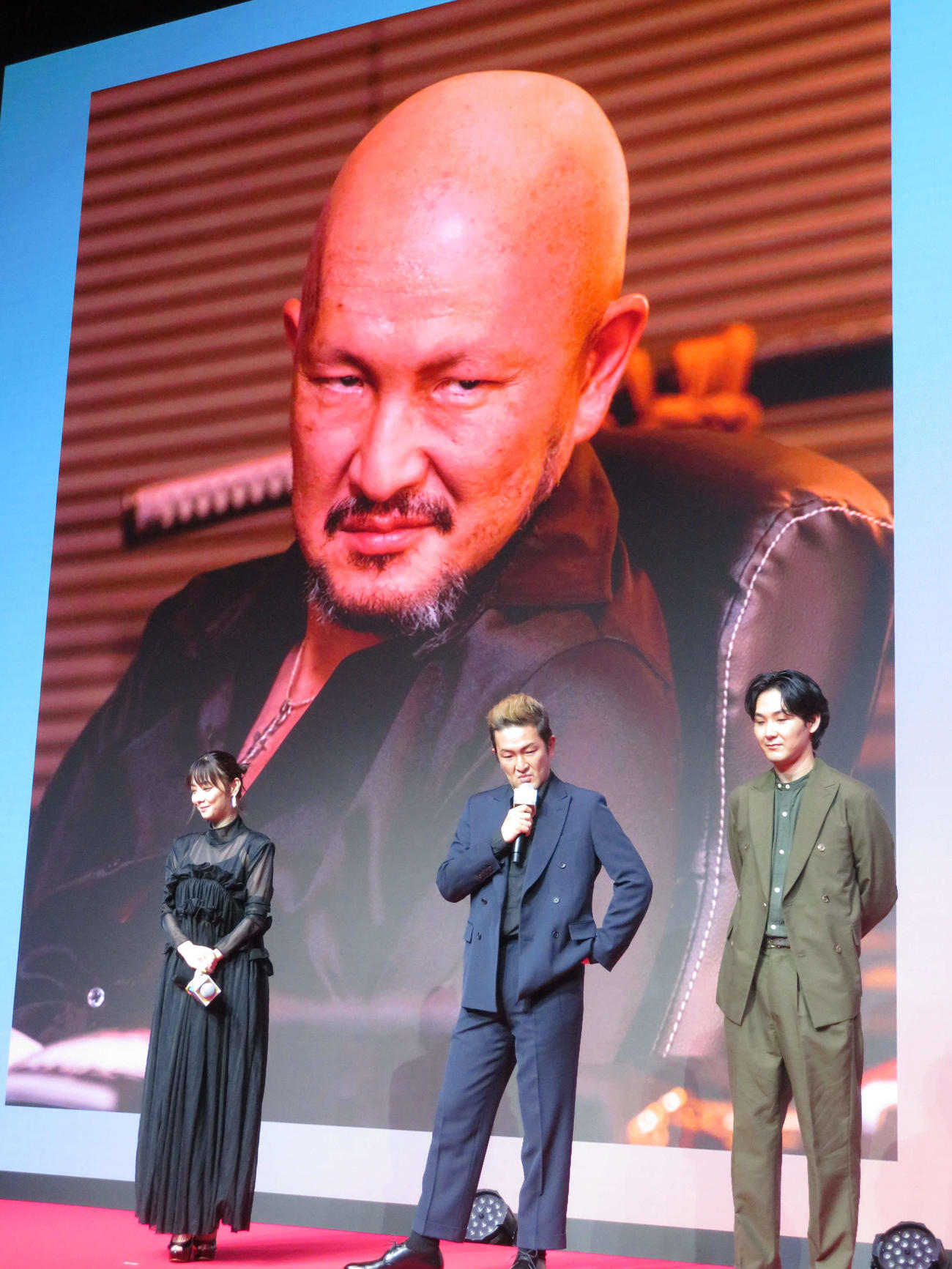 DMM TVオリジナルドラマ「ケンシロウによろしく」完成披露試写会で、中村獅童（中央）の劇中での写真を見つめる倉科カナ（左）と松田龍平（撮影・村上幸将）