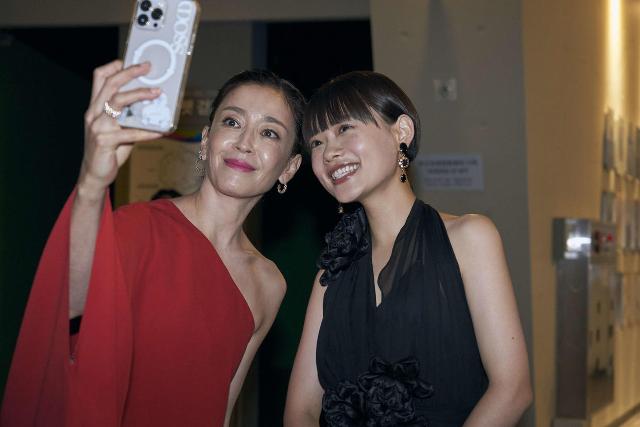 釜山映画祭レッドカーペットで出会い、自撮りする「月」主演の宮沢りえ（左）と「市子」主演の杉咲花（C）2023『月』製作委員会