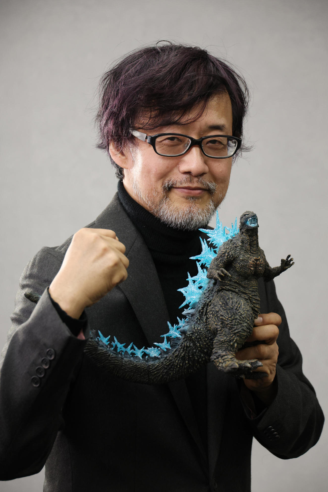ブルーリボン賞受賞会見でゴジラのフィギュアを手にポーズを決める山崎貴監督（撮影・中島郁夫）