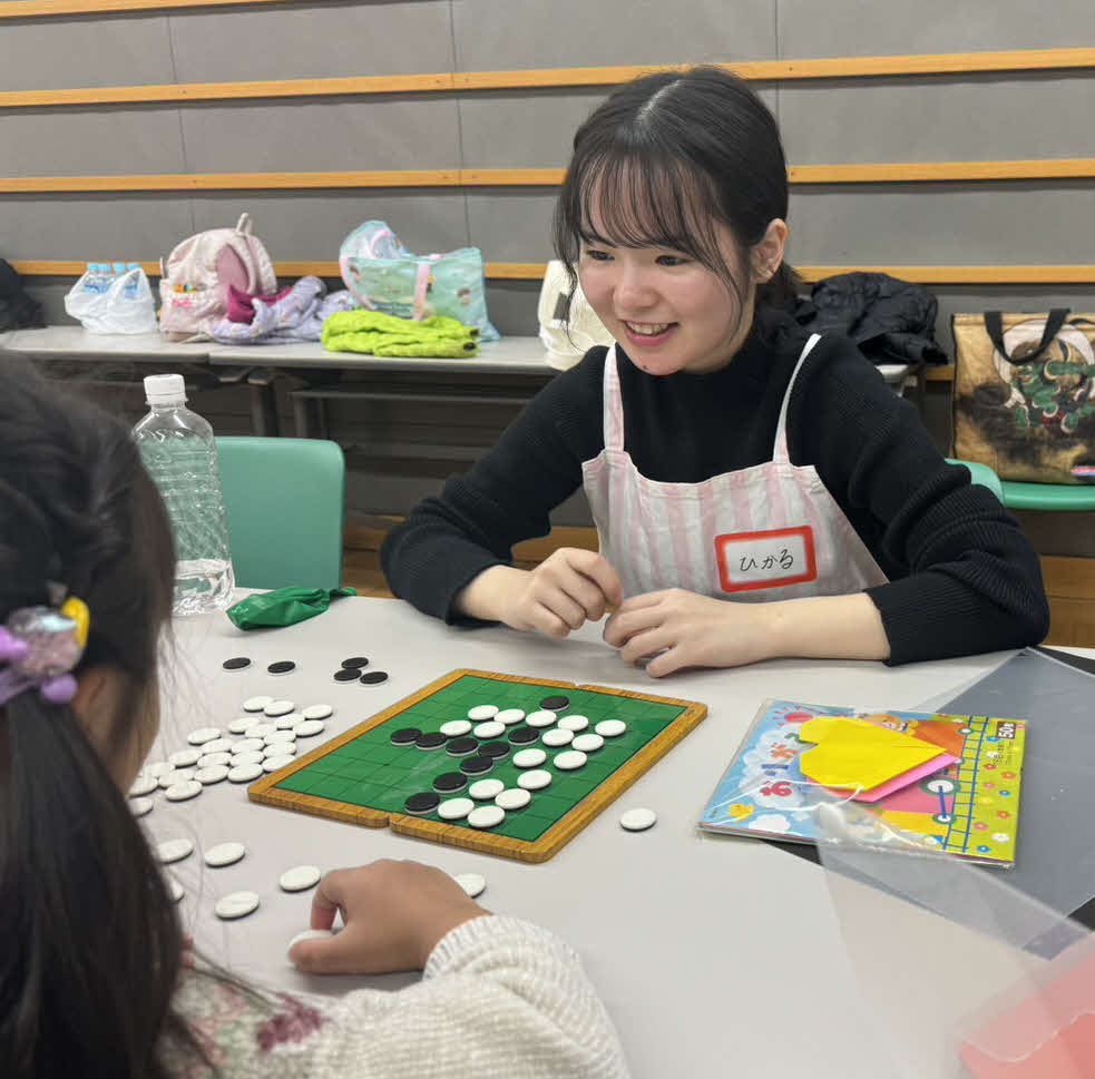 ドラマ現場での初業務で子どもとオセロをする「Fluffy Ket」のキャスト（撮影・松尾幸之介）