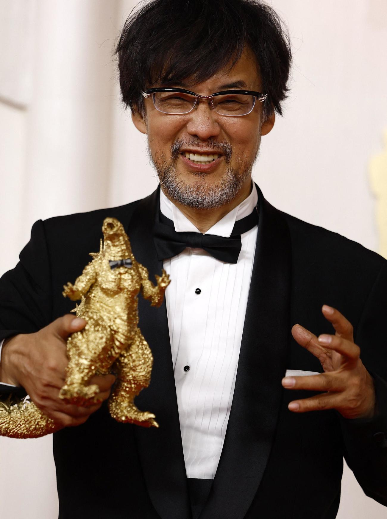 ゴジラのフィギュアを手にレッドカーペットを歩いた山崎貴監督（ロイター）