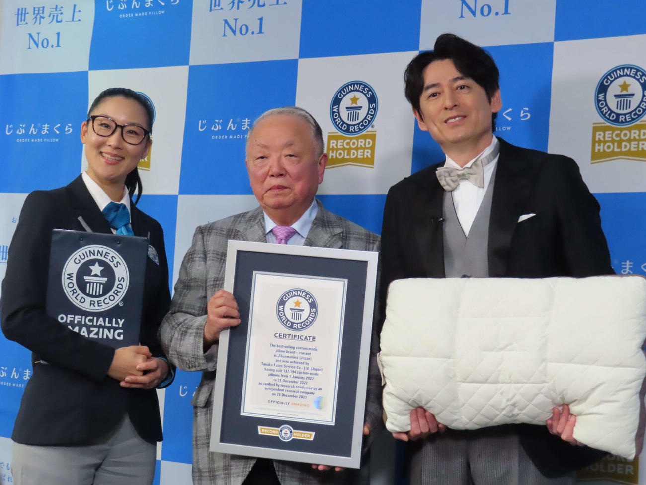 「じぶんまくら」のギネス世界記録認定式に出席した、左からギネスワールドレコーズ審査員、田中公雄社長、博多大吉＝2024年3月12日