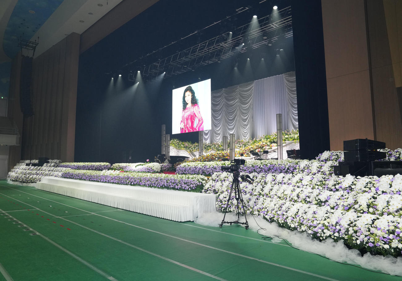 八代亜紀さんがコンサートで使用していた美術セットにコチョウラン、バラ、紫のカーネーションで装飾された祭壇（撮影・江口和貴）