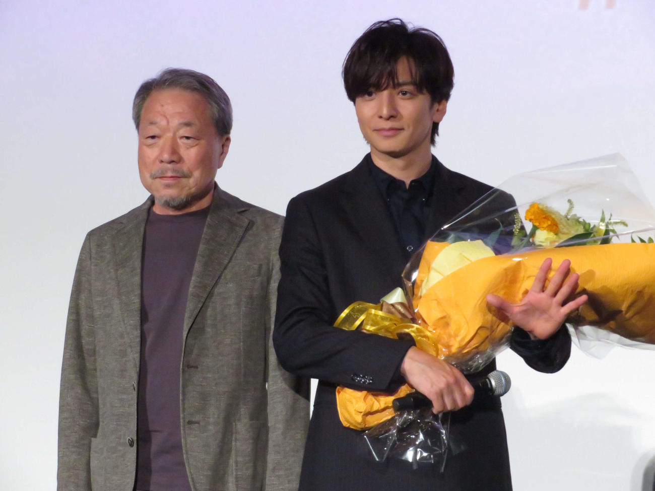 映画「告白　コンフェッション」初日舞台あいさつに登壇し、かわぐちかいじ氏から花束を受け取った生田斗真