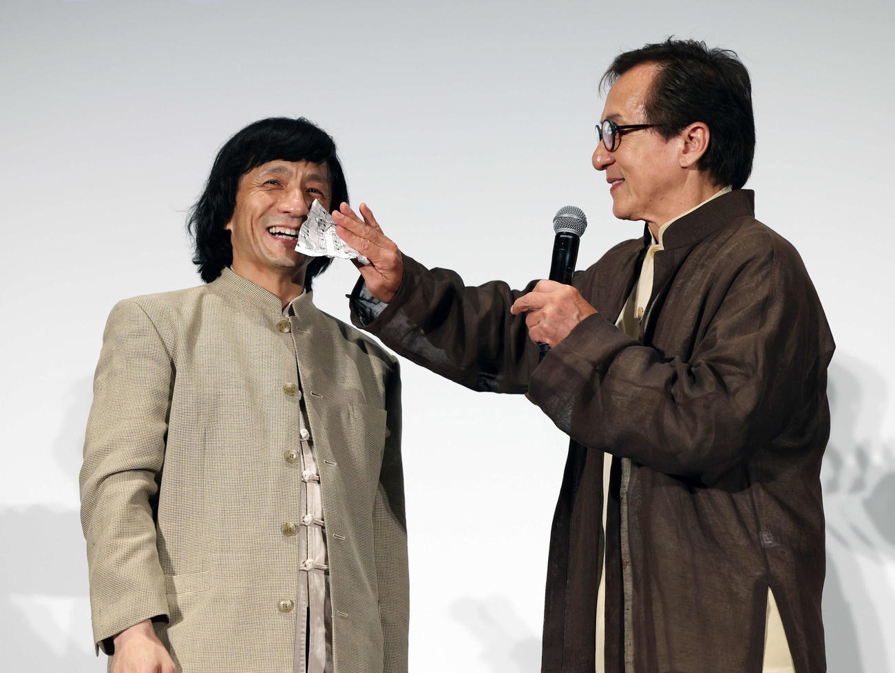 おかえり、ありがとう、ジャッキー！映画「ライド・オン」集大成舞台あいさつでジャッキーちゃん（左）の汗を拭くジャッキー・チェン（撮影・宮地輝）