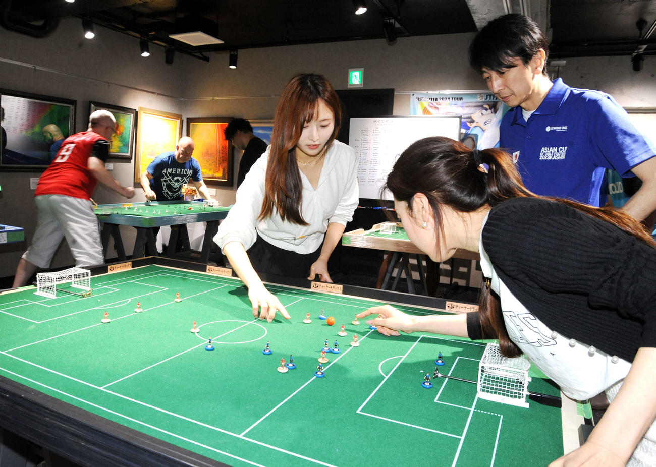 テーブルフットボールの「西会計杯　東京国際オープン2024」で歴史解説YouTuber、囁き女官あくあ（右）と試合をする矢作有紀奈（中央）（撮影・松尾幸之介）