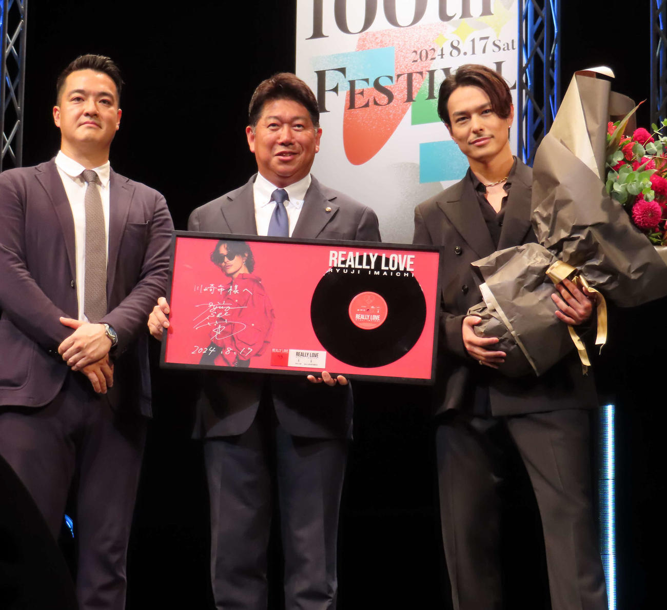 「KAWASAKI・SENZOKU 100th FESTIVAL」に出席し、楽曲提供した三代目　J SOUL BROTHERS今市隆二（右）。左は洗足学園法人本部本部長の前田英三郎さん、中央は川崎市の福田紀彦市長