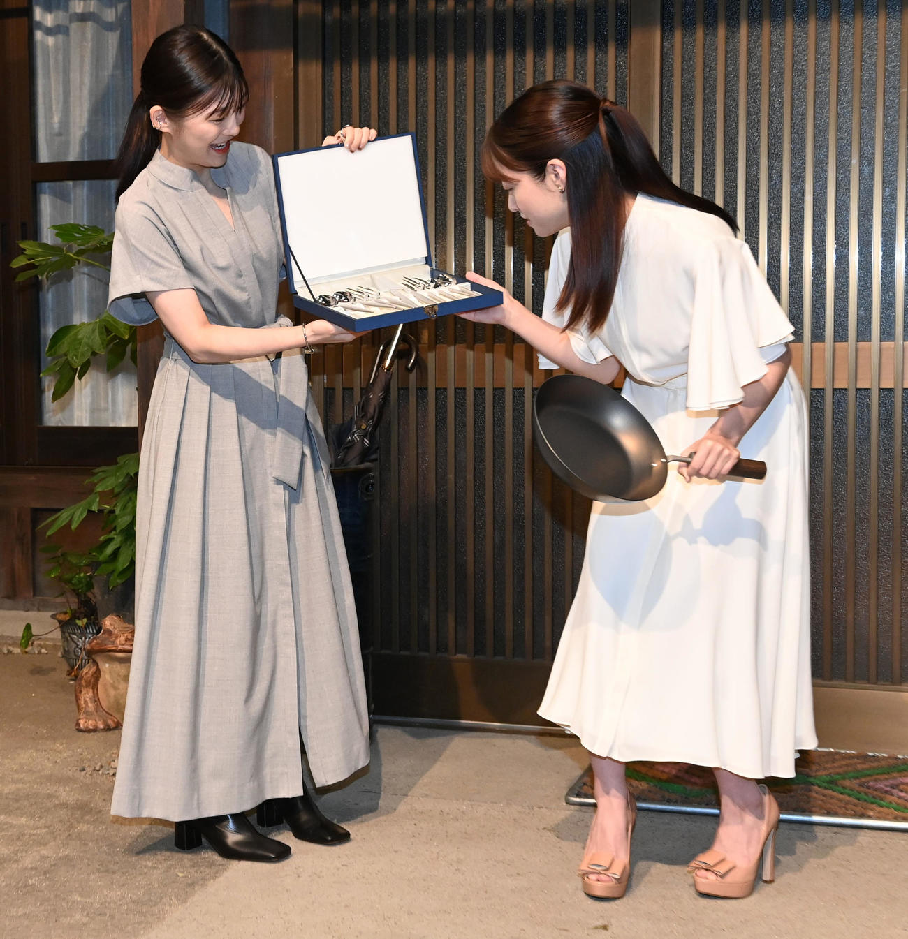 NHK連続テレビ小説「虎に翼」のヒロイン伊藤沙莉（左）からプレゼントされた「おむすび」のヒロイン橋本環奈はフライパンを手に自身の名前が入ったカトラリーセットを見つめる（撮影・前岡正明）