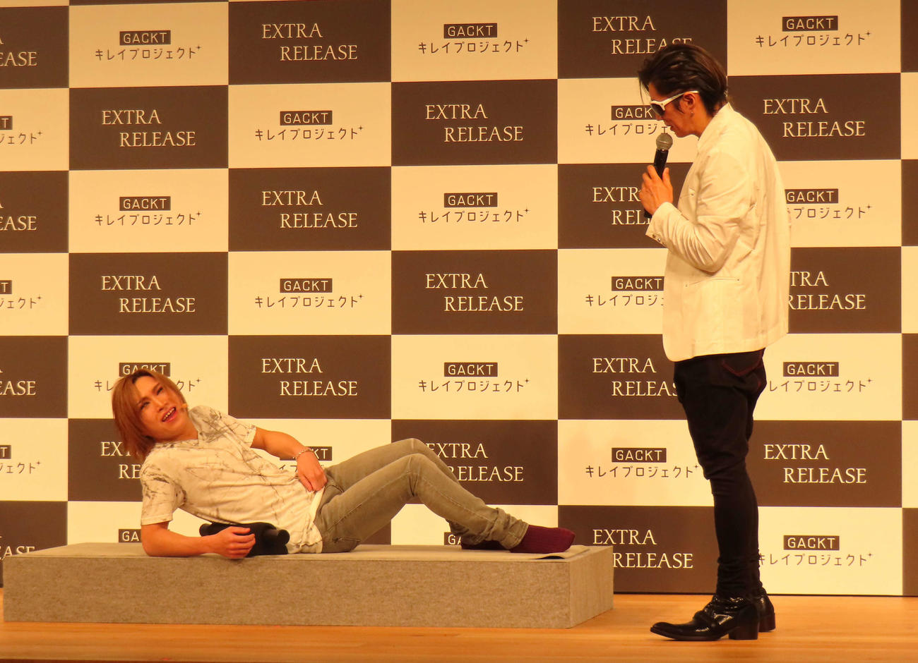 ストレッチローラーを体験するゴールデンボンバー鬼龍院翔（左）とレクチャーするGACKT