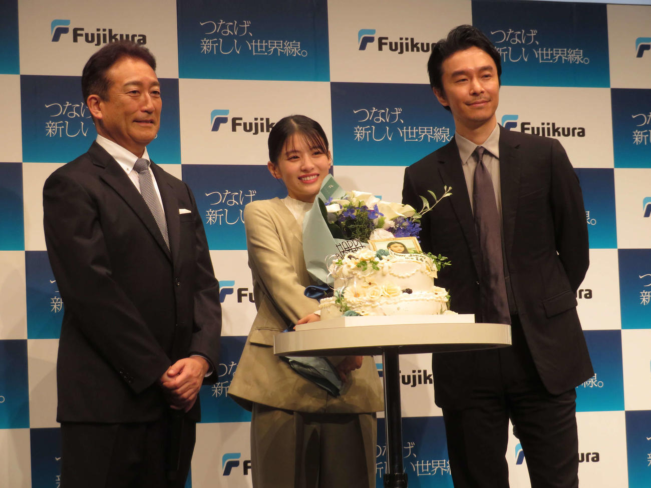「つなげ、新しい世界線。フジクラ新CM発表会」でサプライズで祝福された出口夏希（中央）、左からフジクラ岡田直樹社長、長谷川博己