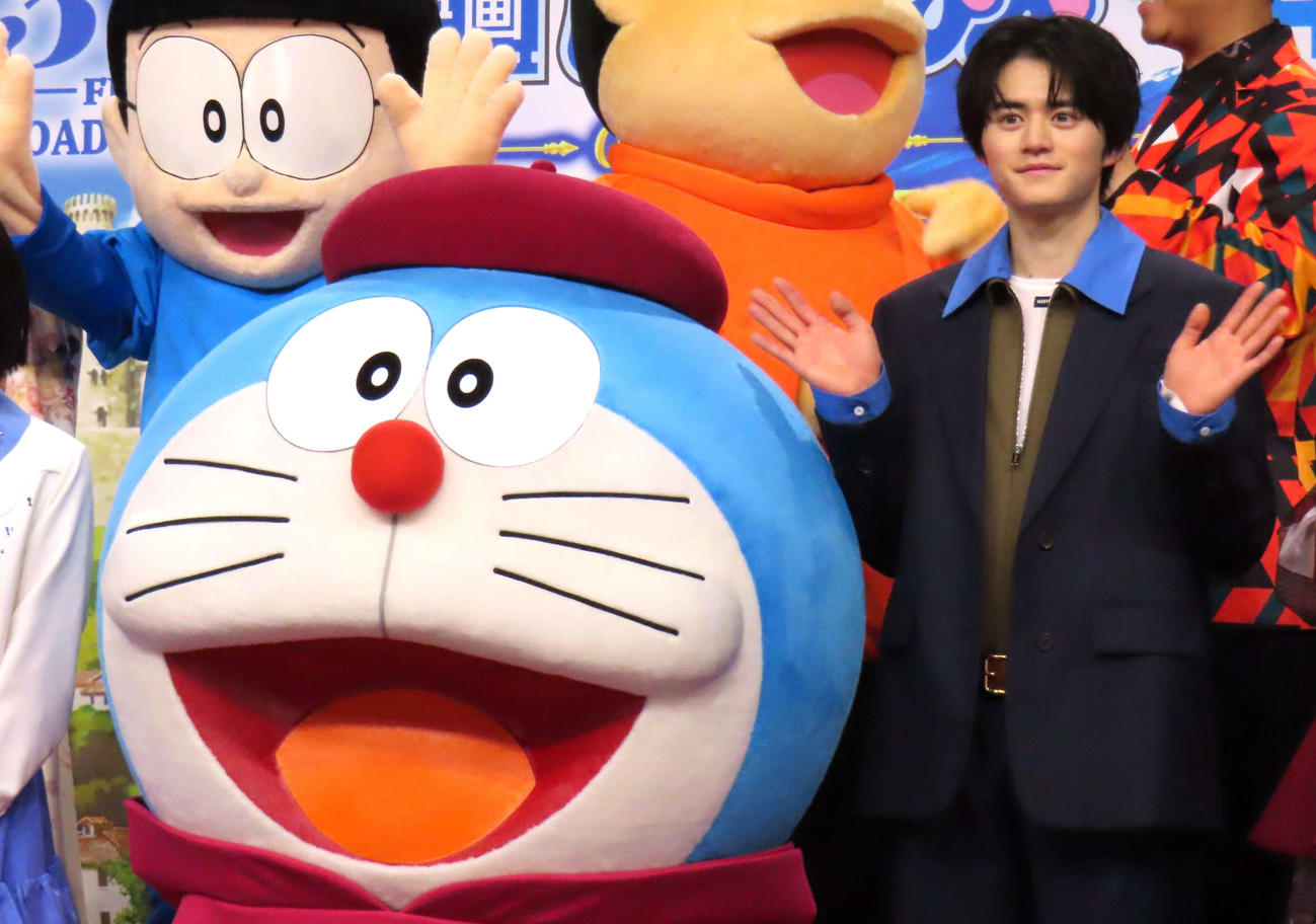ドラえもんと写真に納まる鈴鹿央士
