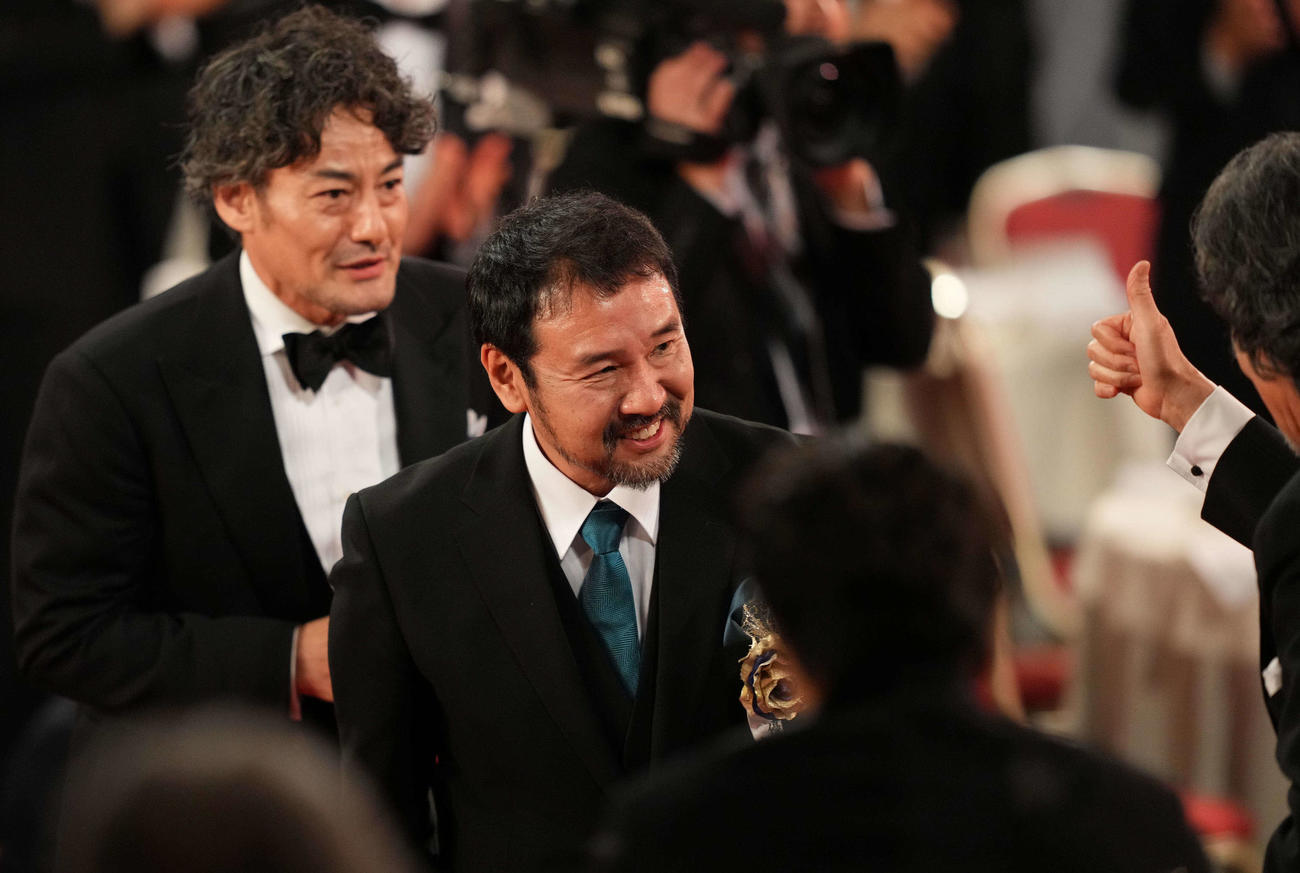 最優秀作品賞に選ばれ拍手を受けながら降壇する映画「侍タイムスリッパー」の安田淳一監督（右）と山口馬木也（撮影・横山健太）