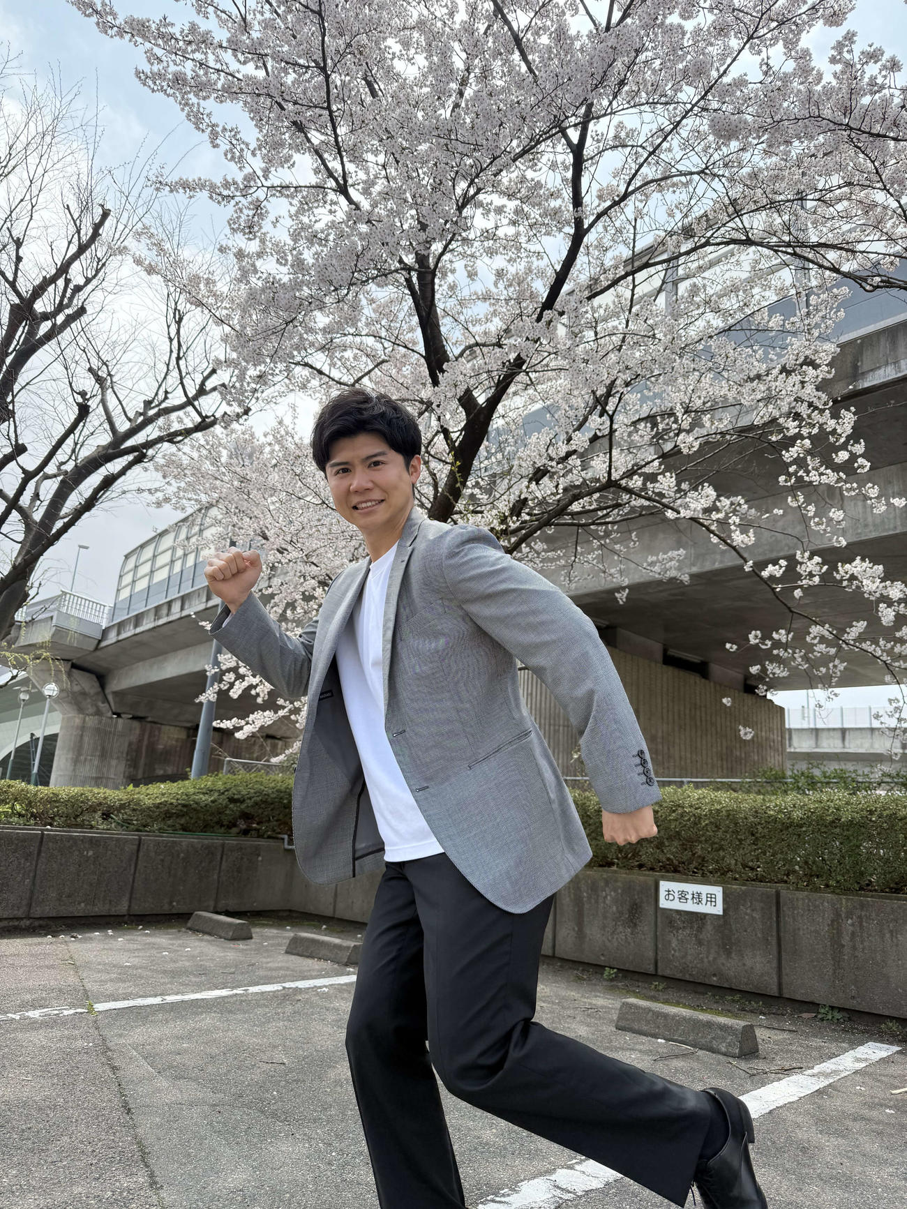 信濃川をのぞむ桜の下で、決意を新たにする大角