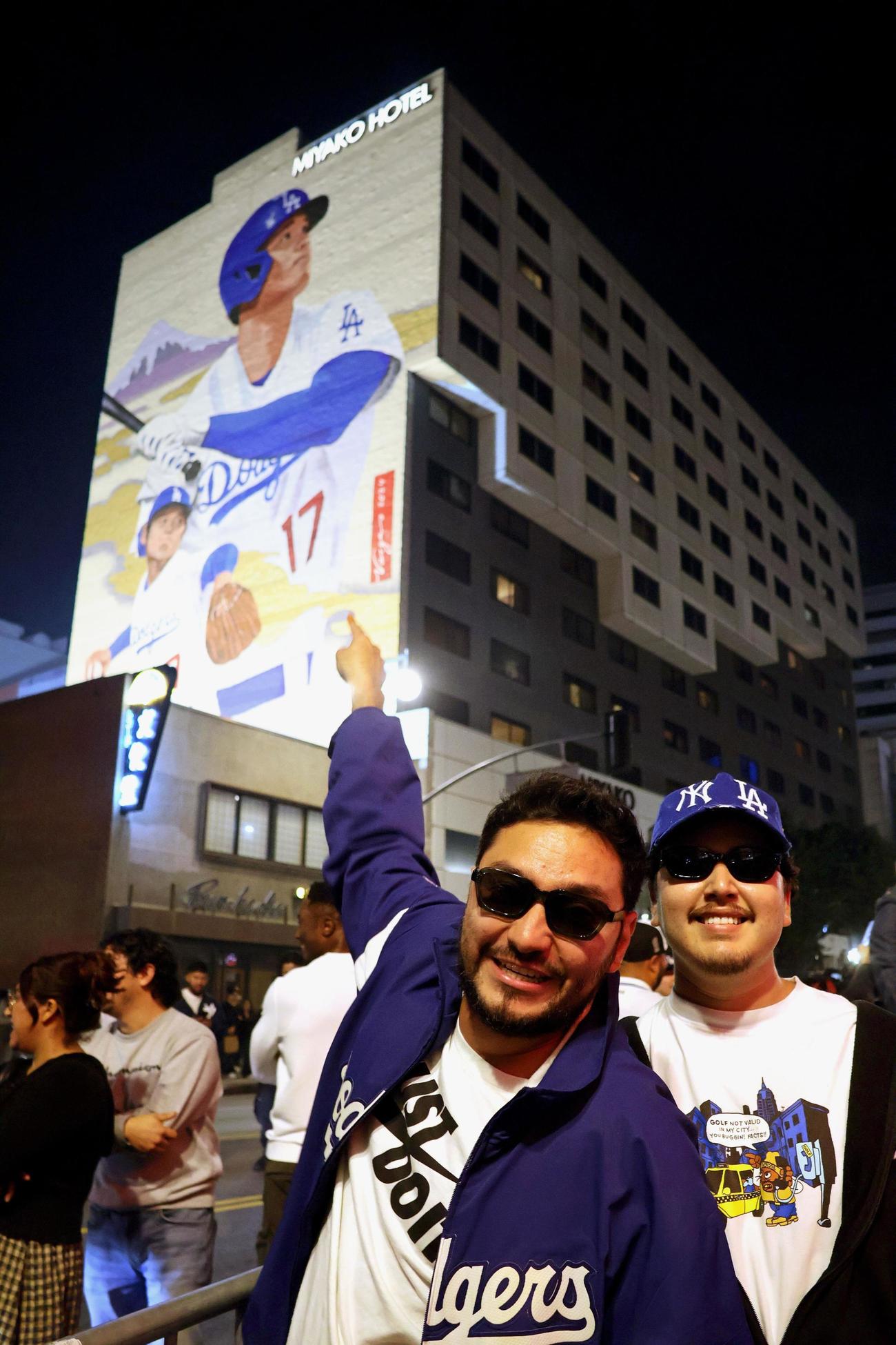 1日、米ロサンゼルス・リトルトーキョーで、ドジャースの大谷翔平選手の壁画を指さすファン（共同）
