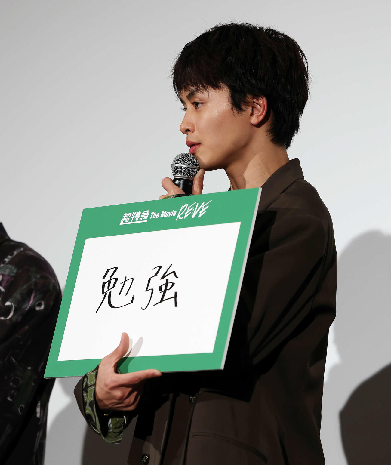 「超特急　The Movie RE：VE」公開初日舞台あいさつで映画の注目ポイントを書いたフリップを持つ超特急のタクヤ（撮影・宮地輝）