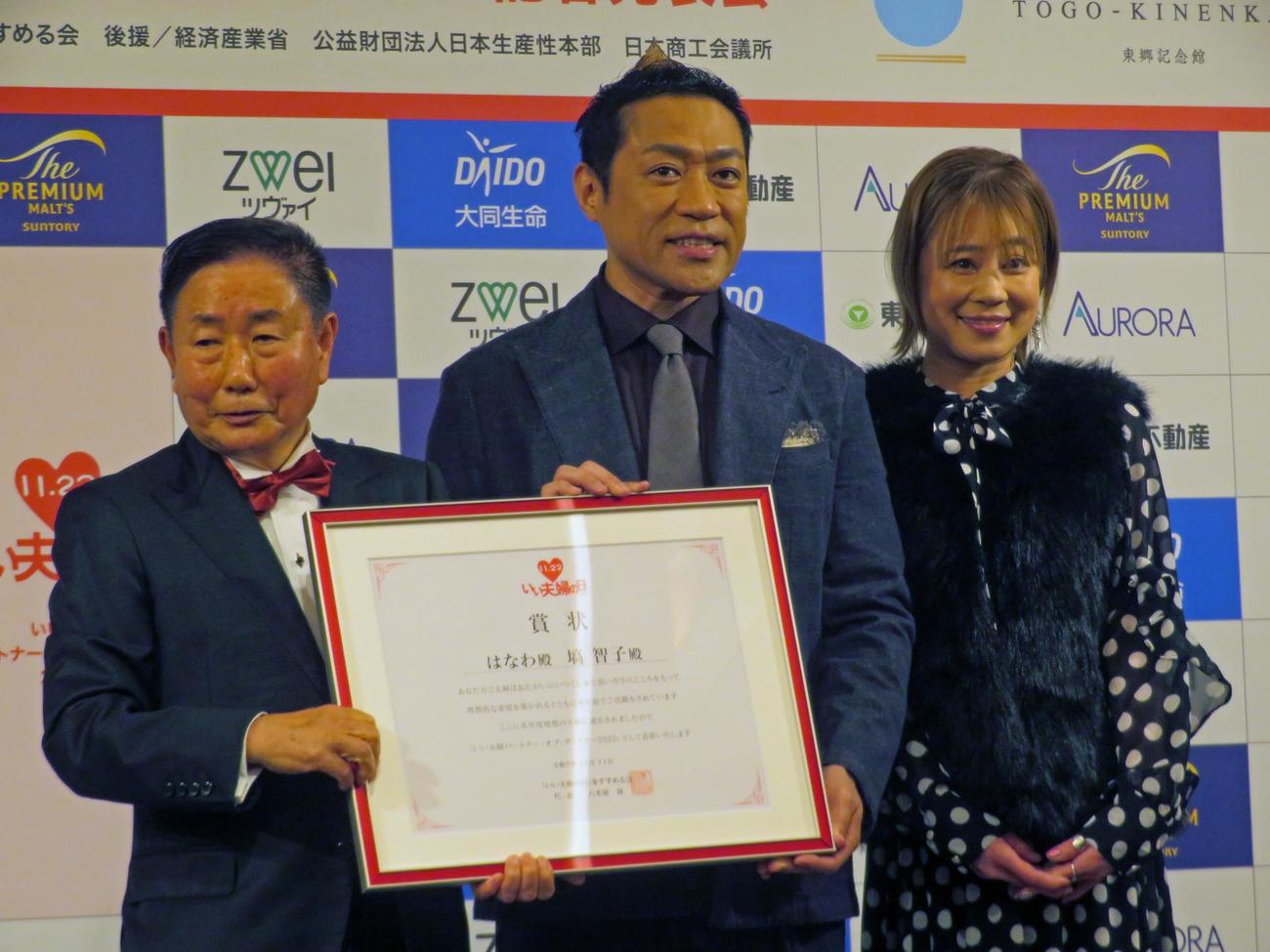 「いい夫婦　パートナー・オブ・ザ・イヤー　2025」に選出され、表彰されたはなわ（中央）と智子さん（右）（撮影・川田和博）