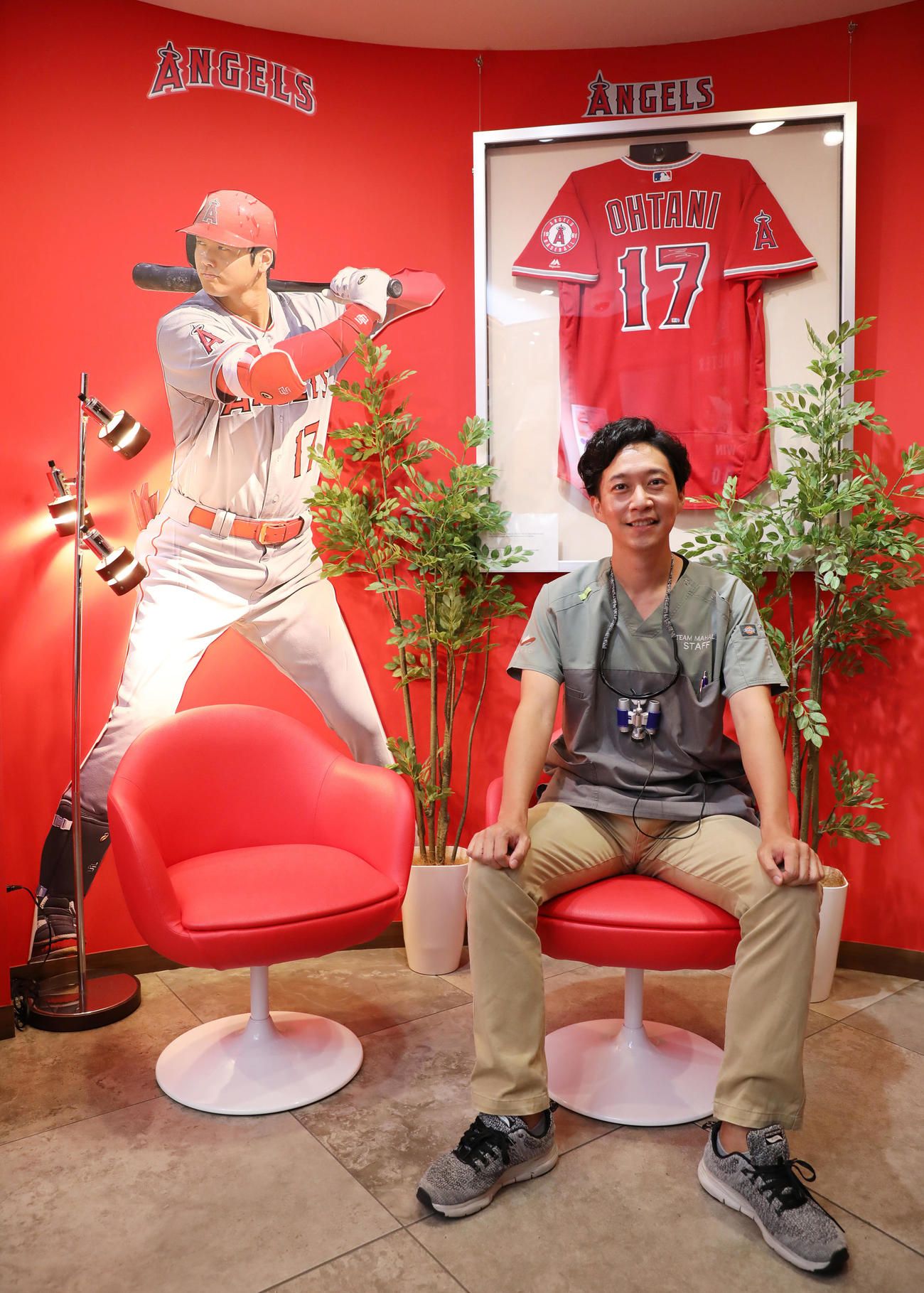 大谷が使用したアイテムなどが多数展示されたかみむら歯科の待合室で笑顔を見せる上村院長（2023年9月20日撮影）