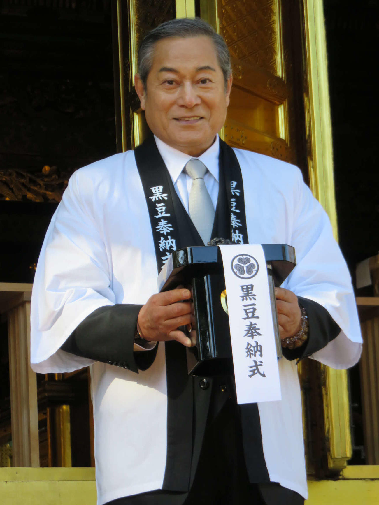 黒豆を持った三宝を手にする松平健