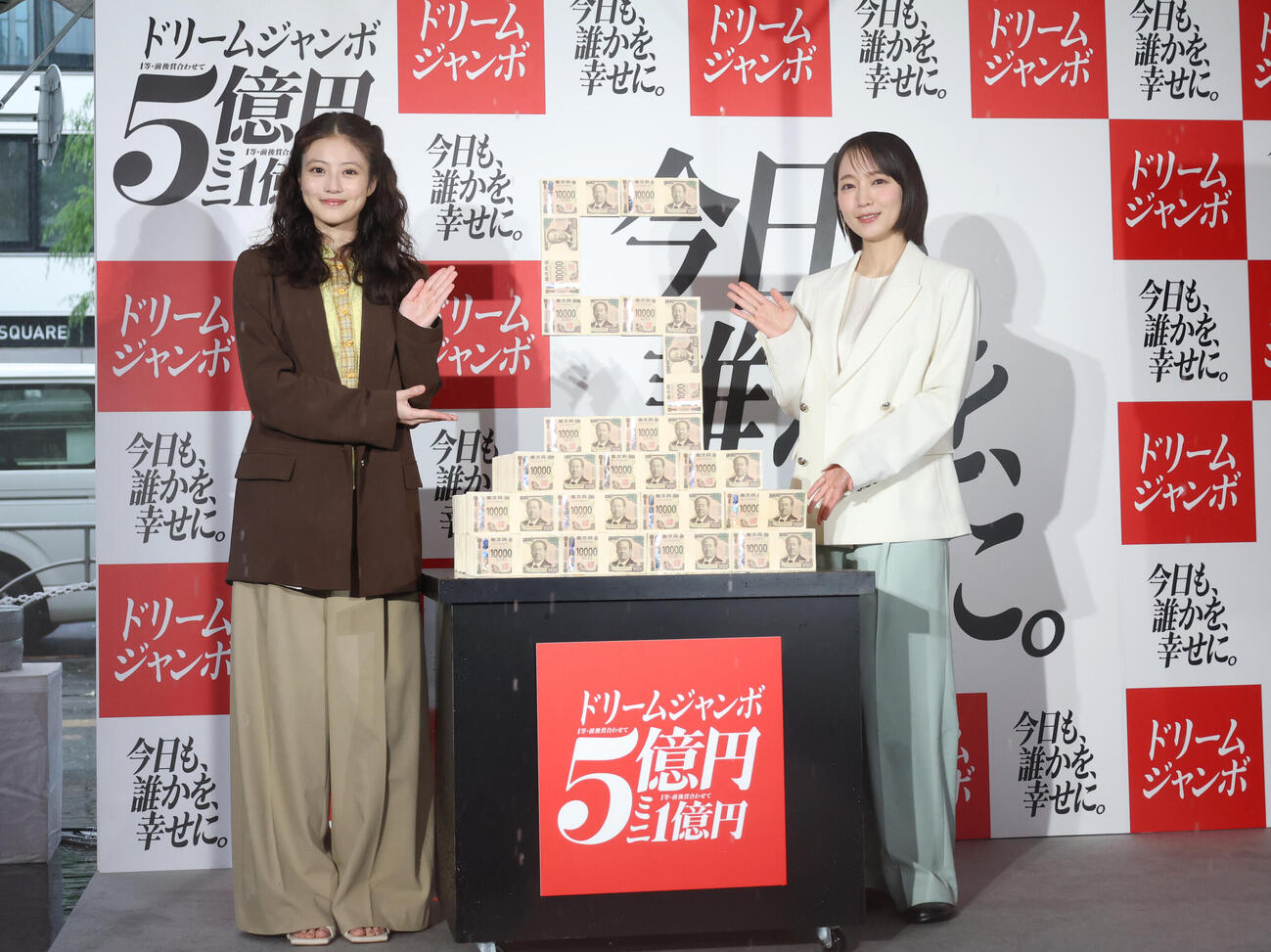 「ドリームジャンボ宝くじ」「ドリームジャンボミニ」発売記念イベントに登壇し5億円ダミー台の横で笑顔を見せる今田美桜（左）と吉岡里帆（撮影・増田悦実）