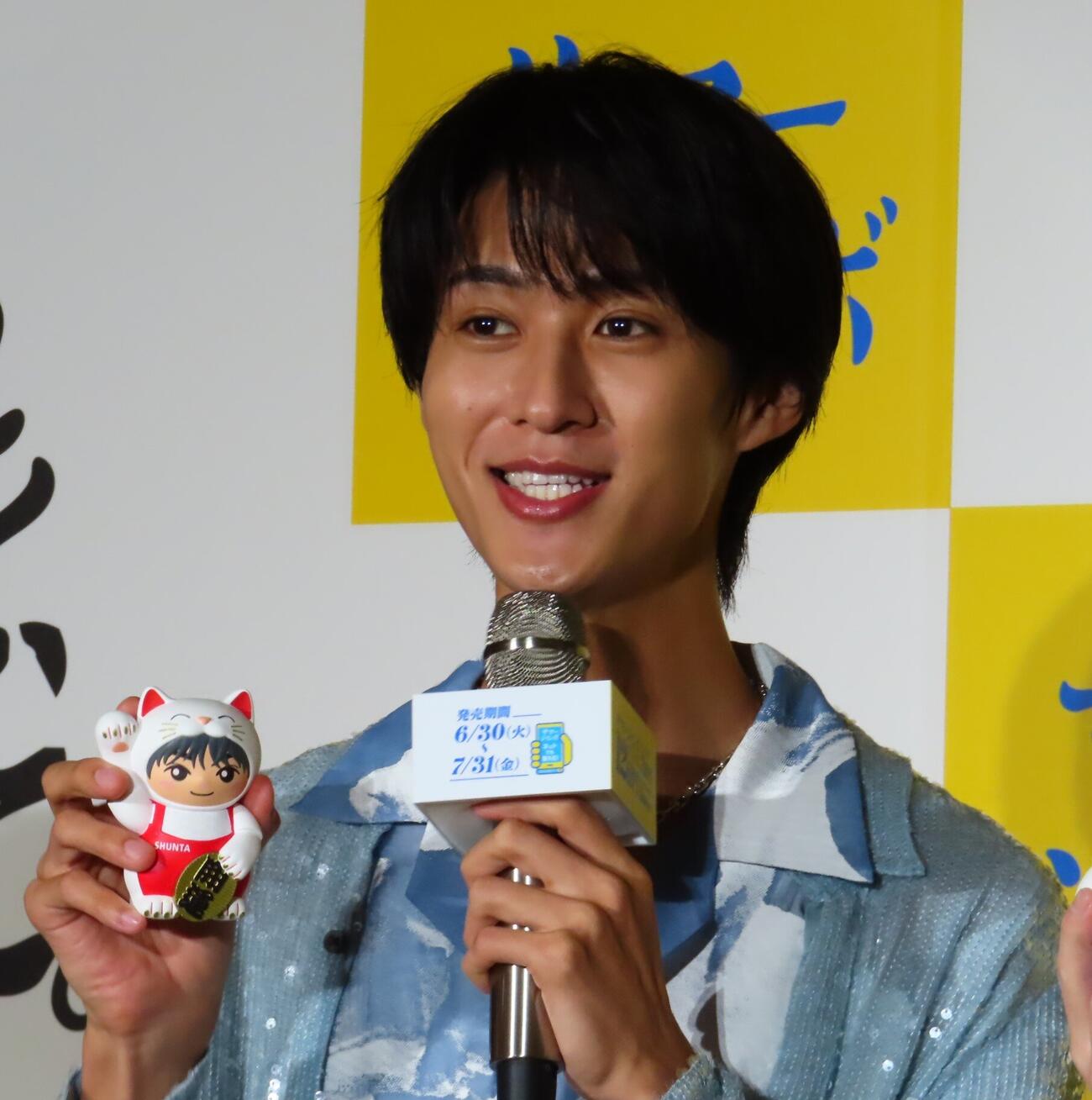 「サマージャンボプレミアム」「サマージャンボ宝くじ」「サマージャンボミニ」発売記念イベントで、自身の顔が描かれた招き猫を手にする曽野舜太