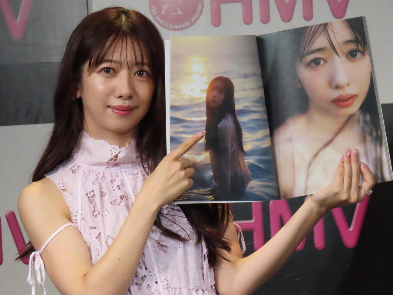 2nd写真集「まちあわせ」のお気に入りページを指さす真山りか