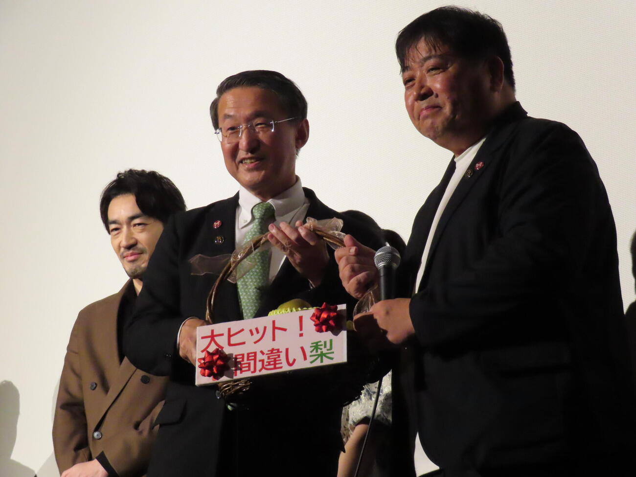 映画「遥かな町へ」公開初日舞台あいさつに登壇した錦織良成監督（右）と鳥取県の平井伸治知事。後ろは大谷亮平