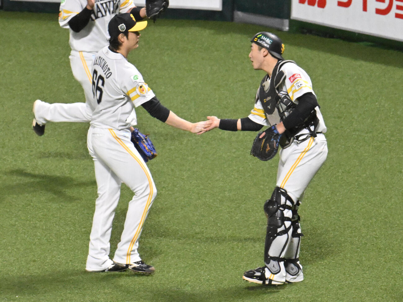ソフトバンク対DeNA 8回表終了後、タッチを交わす松本裕樹（左）と山本祐大（撮影・林敢治）