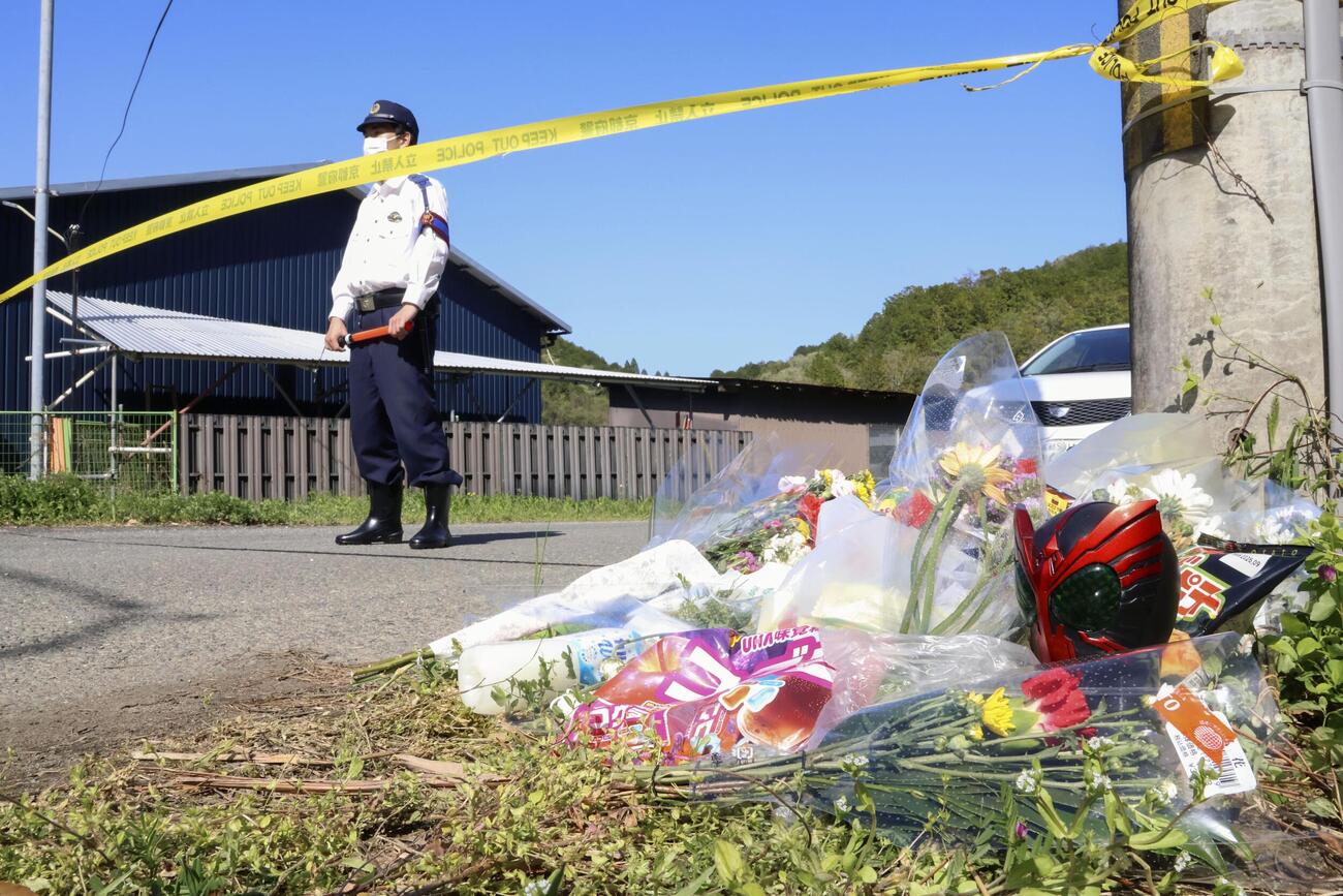 安達結希さんの遺体が発見された現場付近に供えられた花束や飲み物など（共同）