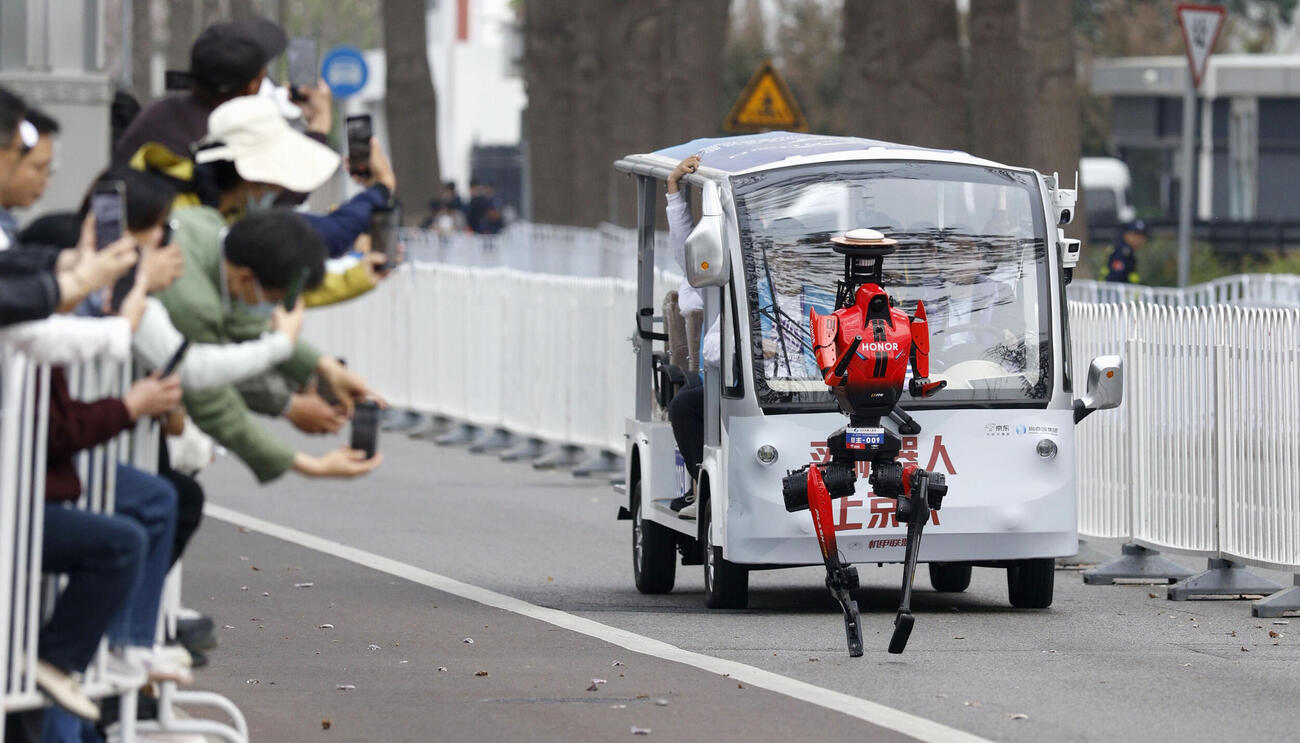 人型ロボットによるハーフマラソン大会で走るロボット。50分26秒でゴールしハーフマラソン男子の世界記録を上回った（共同）