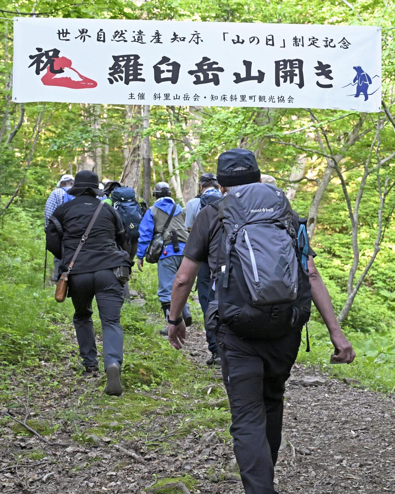 山開きが行われた羅臼岳の岩尾別登山口から登山に向かう人たち（共同）