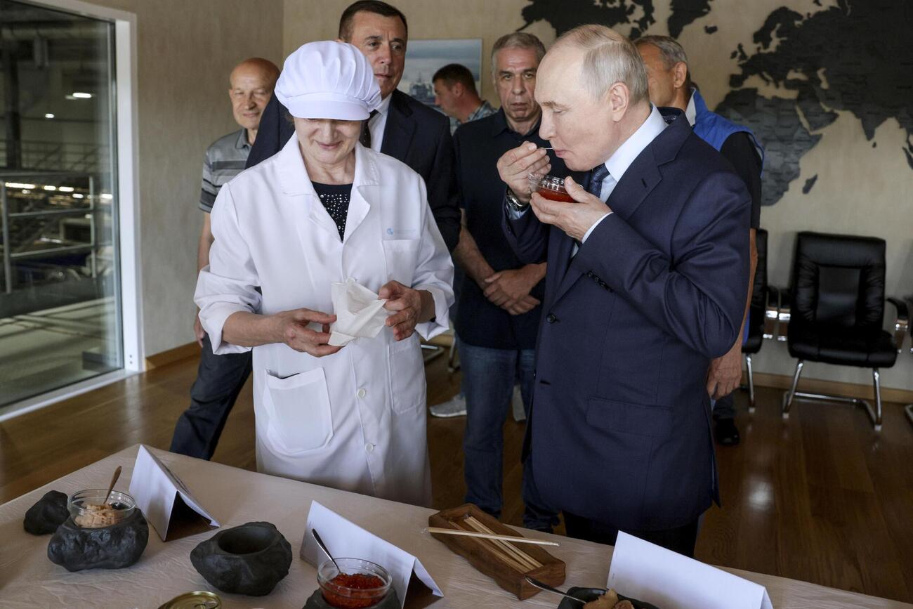 13日、北方領土・択捉島の工場を訪れたロシアのプーチン大統領（手前右）（タス＝共同）