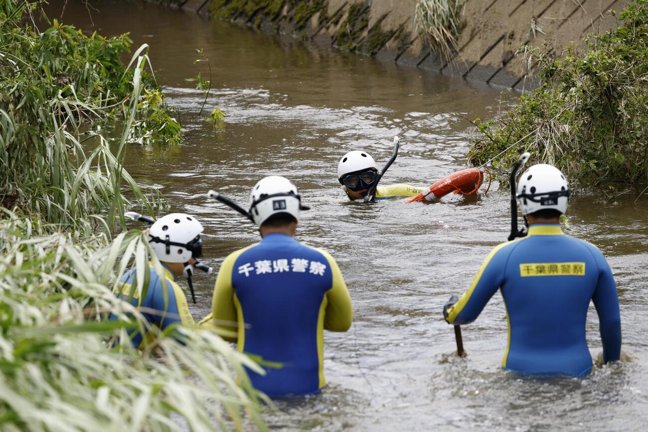 大雨被害を受けた千葉市若葉区で、行方不明者の捜索に当たる警察官(共同)