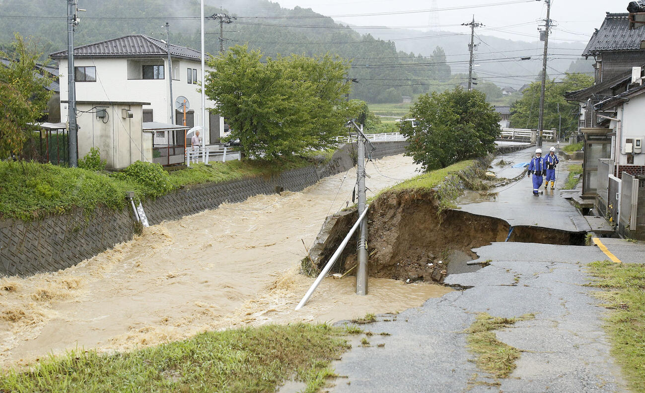 大雨の影響で崩れた石川県羽咋市の飯山川沿いの道路（共同）