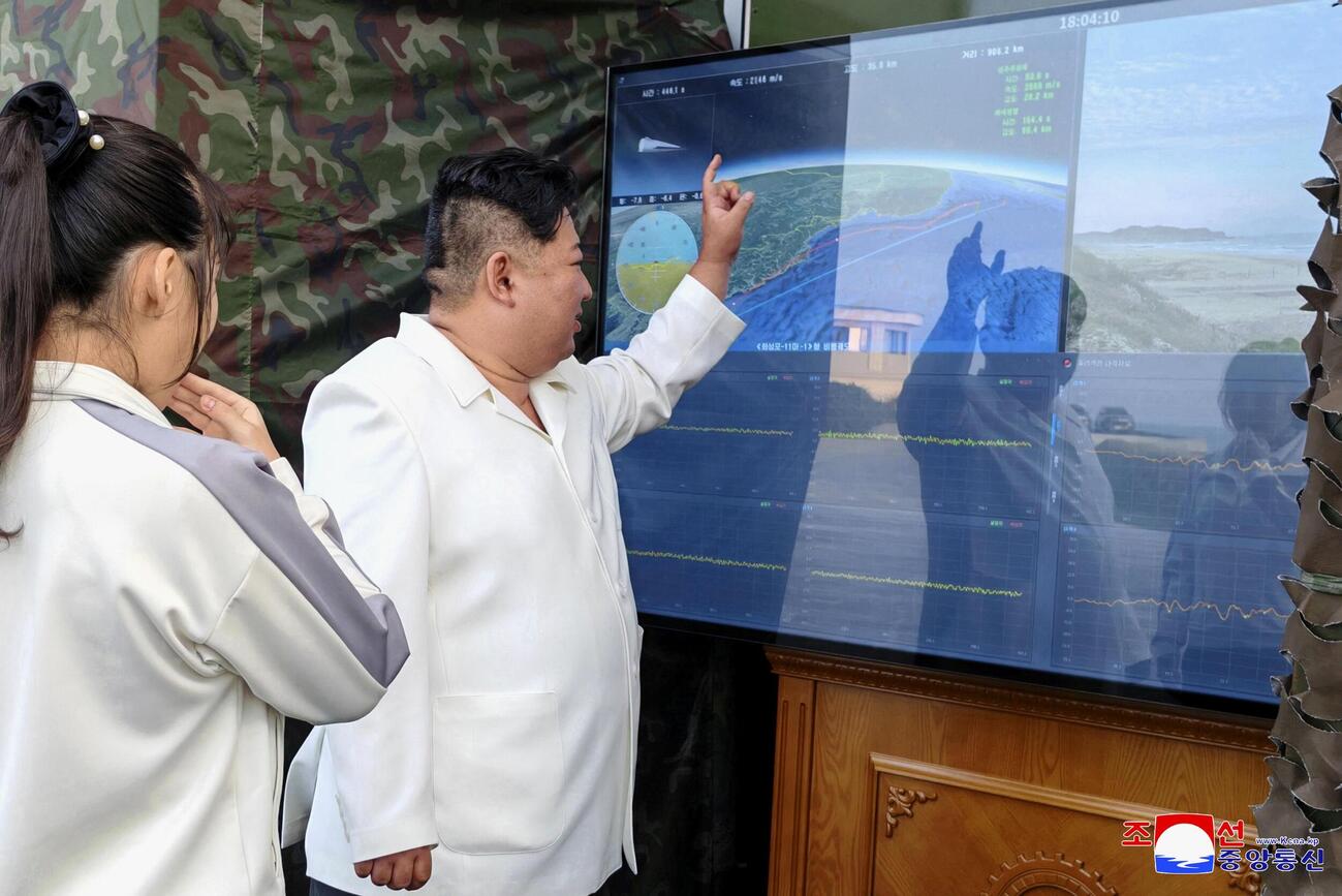 北朝鮮のミサイル総局が実施した新型兵器の試験をモニターで確認する金正恩朝鮮労働党総書記（右）と娘＝20日（朝鮮中央通信＝共同）