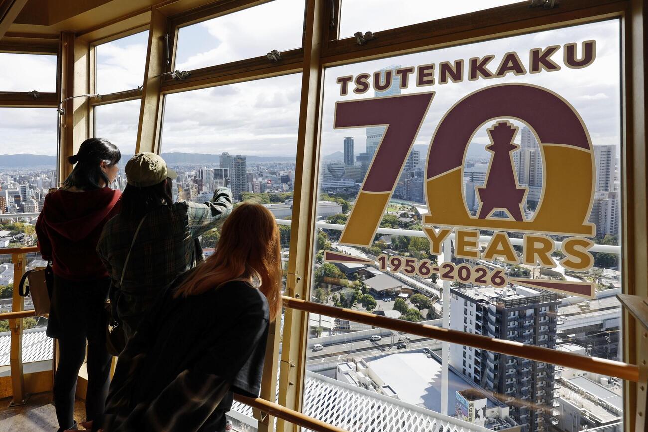 「70YEARS」の文字などで飾られた「通天閣」の展望台を訪れた観光客（共同）