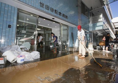 13日午前7時58分、東京都世田谷区　浸水した世田谷記念病院で掃除をする人たち（共同）