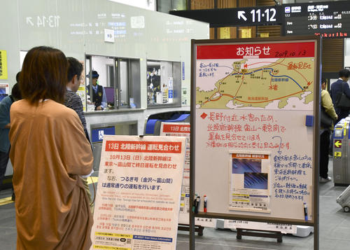 13日午前11時45分　台風19号による大雨の影響で北陸新幹線の車両基地が水没し、JR富山駅の改札口に掲示された東京－富山間の運休の案内