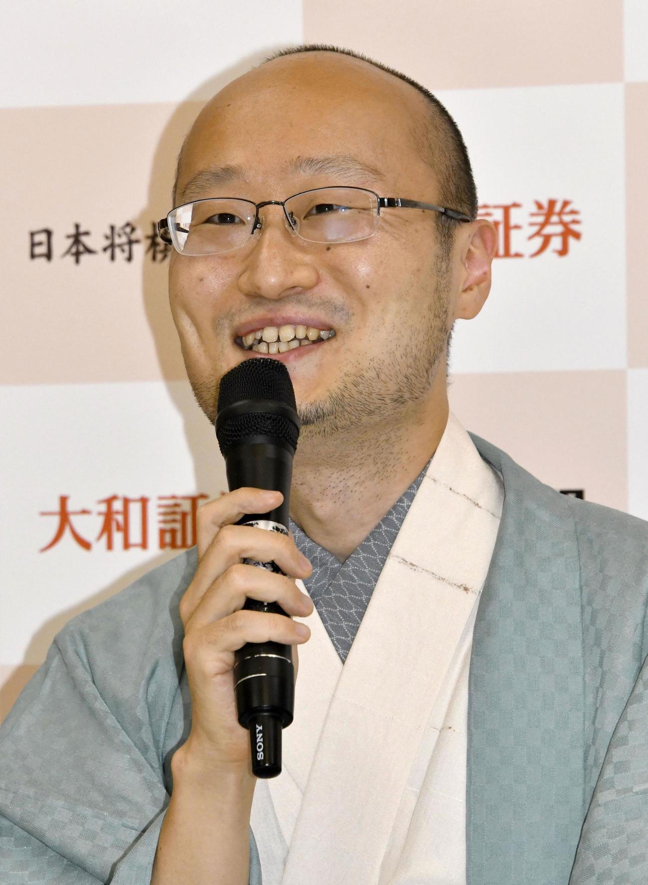 記者会見で笑顔を見せる名人位獲得の渡辺明2冠（共同）