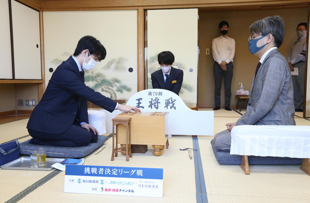 初手を指す藤井聡太2冠。右は羽生善治九段（代表撮影）
