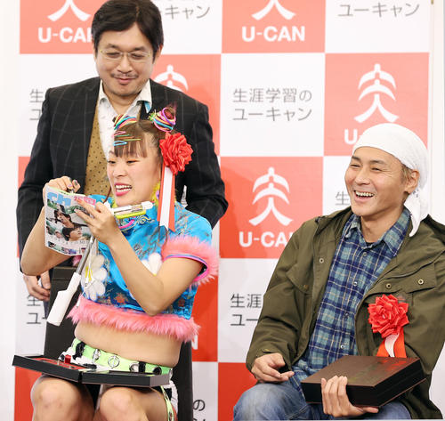 「新語・流行語大賞」発表・表彰式の記念撮影後、、選考委員のやくみつる氏（後方）からお願いされてサインするフワちゃん。右はヒロシ（撮影・浅見桂子）