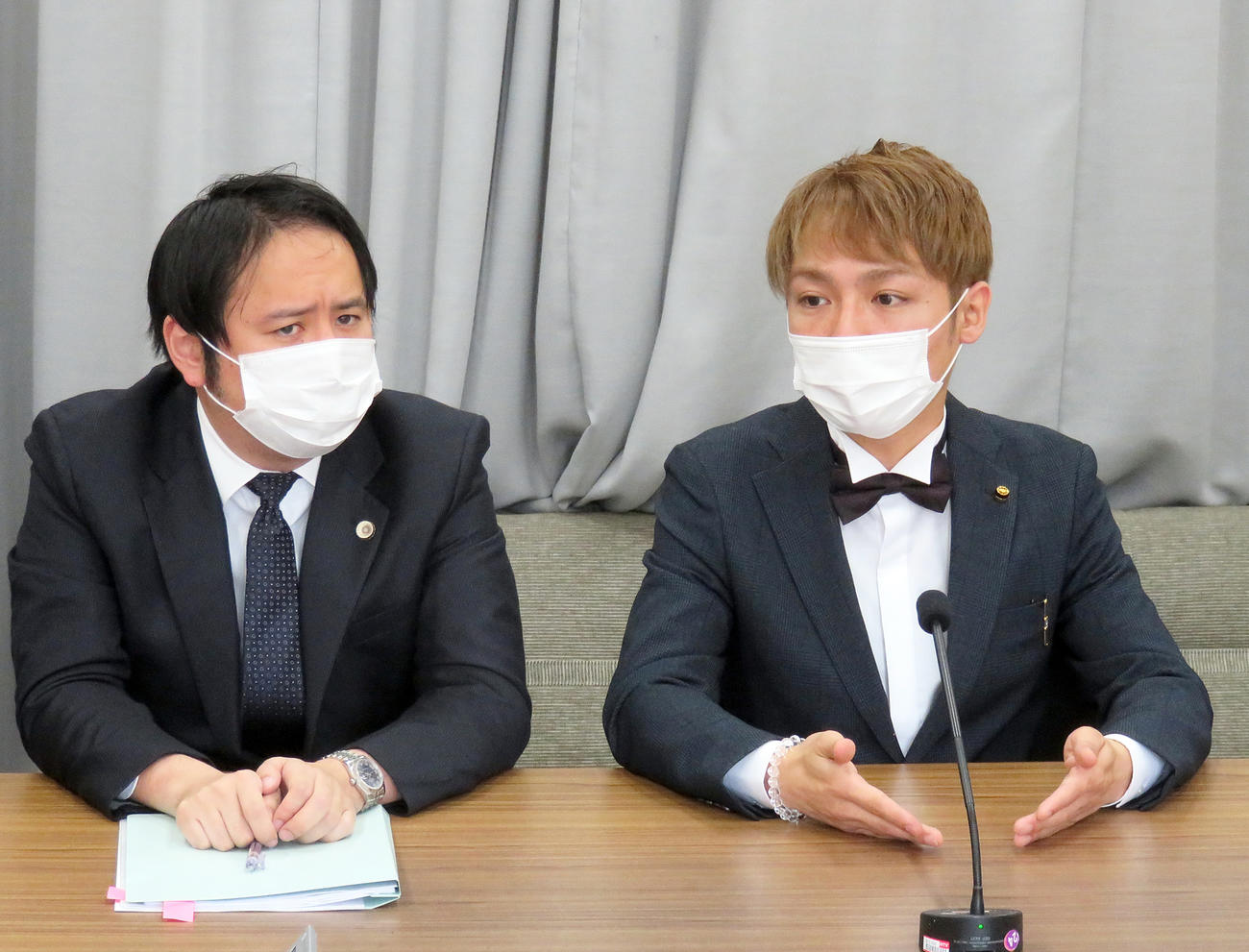 審査申し立て書提出後の会見で、記者の質問に答えるスーパークレイジー君議員（右）。左は加藤博太郎弁護士（撮影・鎌田直秀）