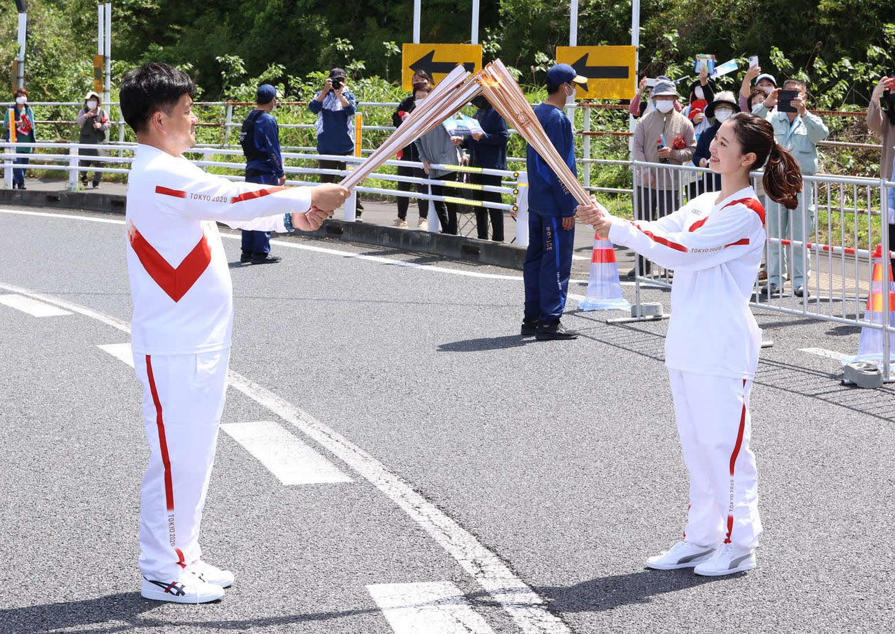聖火ランナーを務めた木藤亮太さん（左）と次走者で2019ミスジャパン宮崎代表の中野愛美さん（代表撮影）