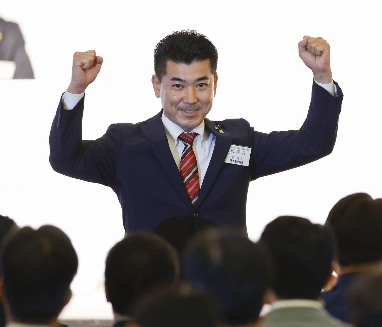 立憲民主党の新代表に選出され、笑顔を見せる泉健太氏＝30日午後、東京都内のホテル（共同）