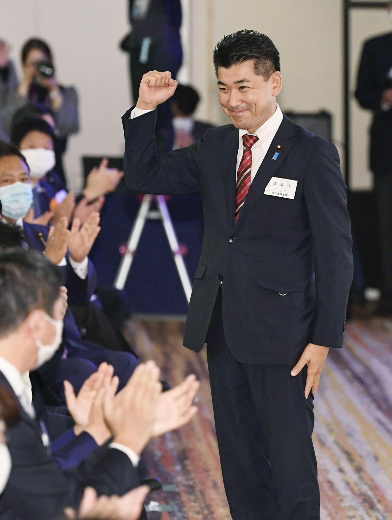 立憲民主党の新代表に選出され、笑顔を見せる泉健太氏＝30日午後、東京都内のホテル（共同）